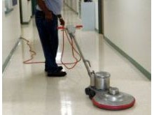 Janitor at a public school burnishing the floor